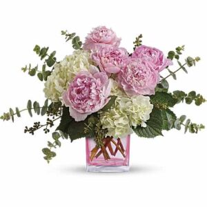 Peony and hydrangea bouquet in pink glass vase