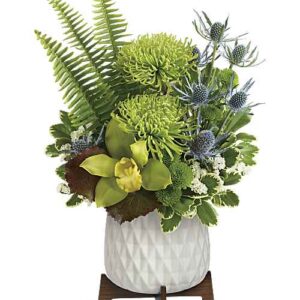 Green cymbidium orchid and chrysanthemum bouquet in ceramic planter